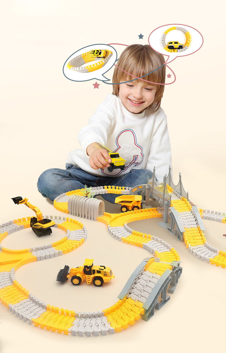 Child playing with a yellow car on an assembled race track with bridges and construction vehicles