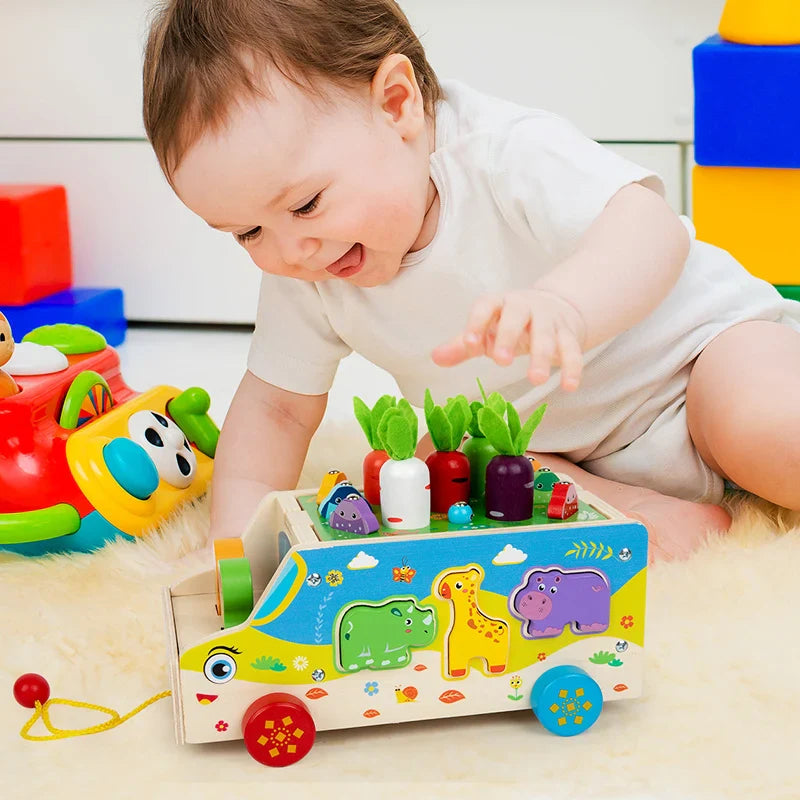 Child reaching for vegetable pieces on the animal-matching pull-along bus
