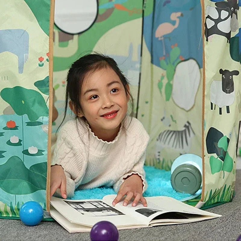 Child reading a book at the open doorway of the animal-print play tent