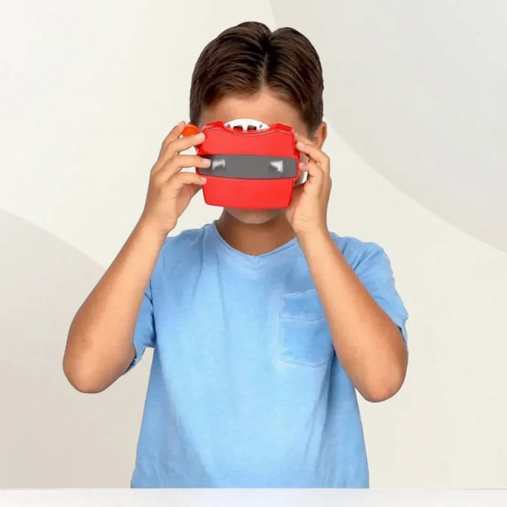 Child looking through a red handheld 3D picture viewer