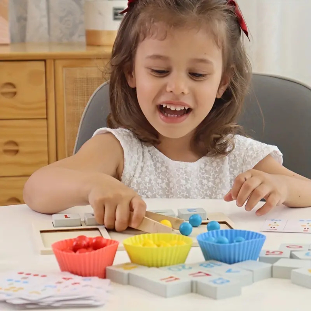 Child using tweezers to move counting beads between colorful sorting bowls