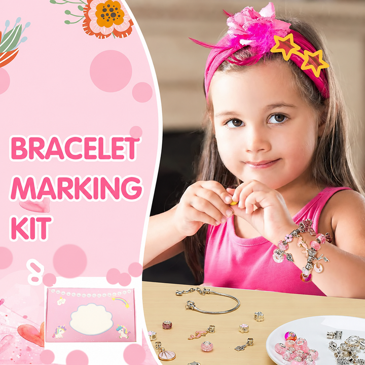 Child wearing a charm bracelet at a table with loose beads and jewelry-making pieces