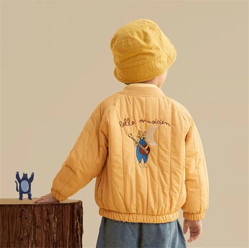 Child wearing a yellow quilted winter coat, showing the embroidered back and gathered hem