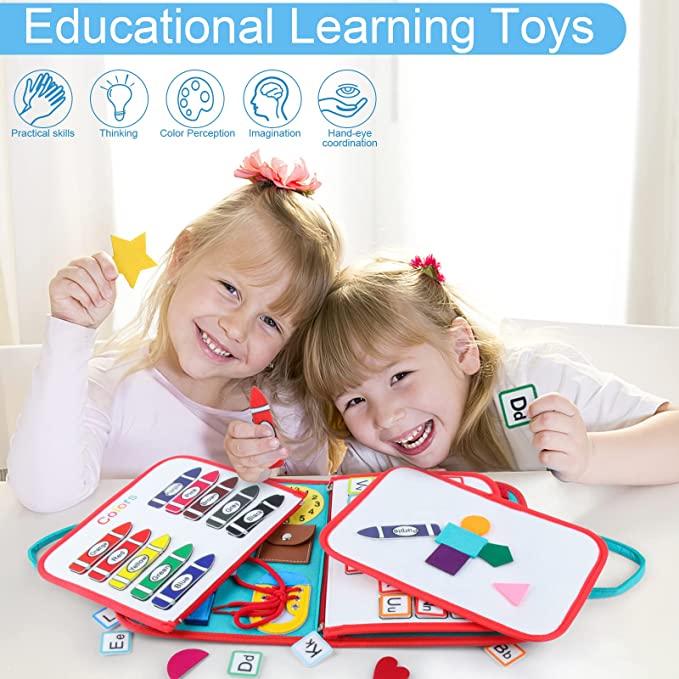 Two children exploring alphabet and shape activities in an open busy book