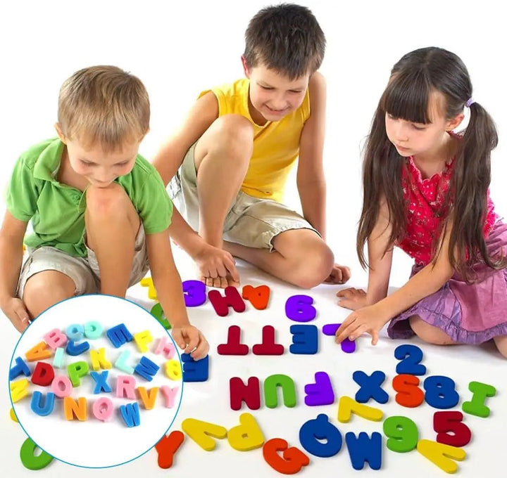 Three children arranging colorful alphabet and number pieces on the floor