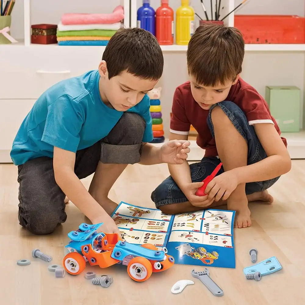 Two children building a blue and orange car with tools, loose parts, and an illustrated guide