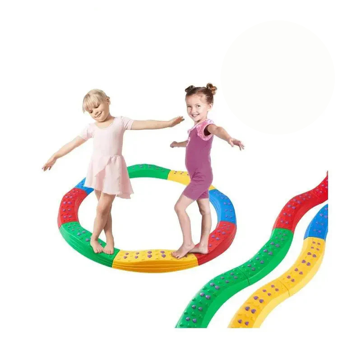 Two children balancing on a circular beam beside winding multicolor beam layouts
