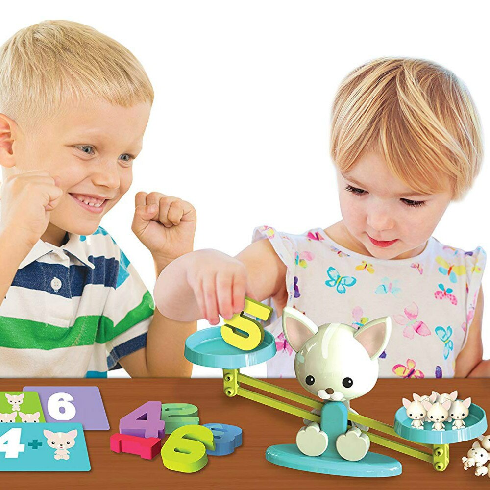 Two children playing with the dog balance scale, numeral weights, and animal counters