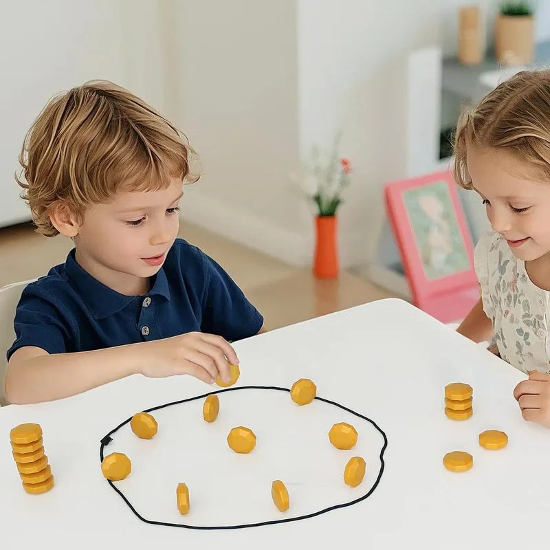 Two children playing with gold magnetic stones inside a cord loop