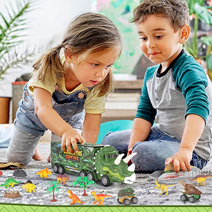 Two children playing with a dinosaur carrier truck, small cars, and dinosaur figures