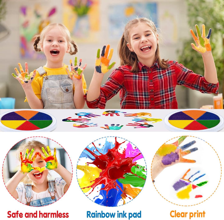 Two children showing painted hands above a table with round color pads and handprint art