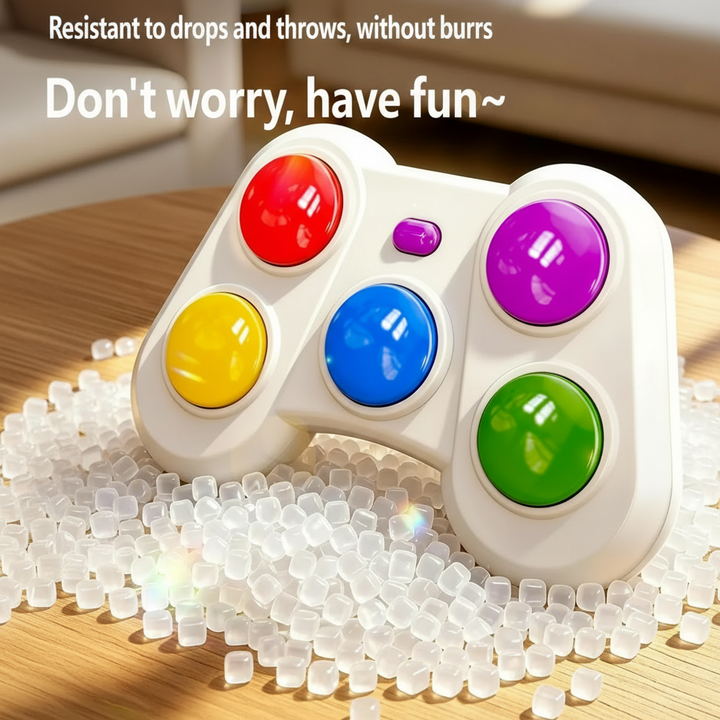 Five-button game controller resting on translucent plastic pellets
