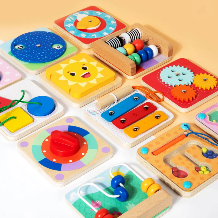 Close-up of colorful wooden activity boards with a turning dial, gears, counting beads, and a bead maze.