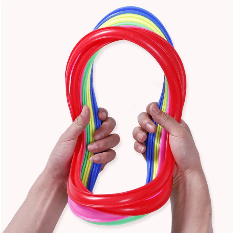 Hands holding a bent stack of colorful play hoops