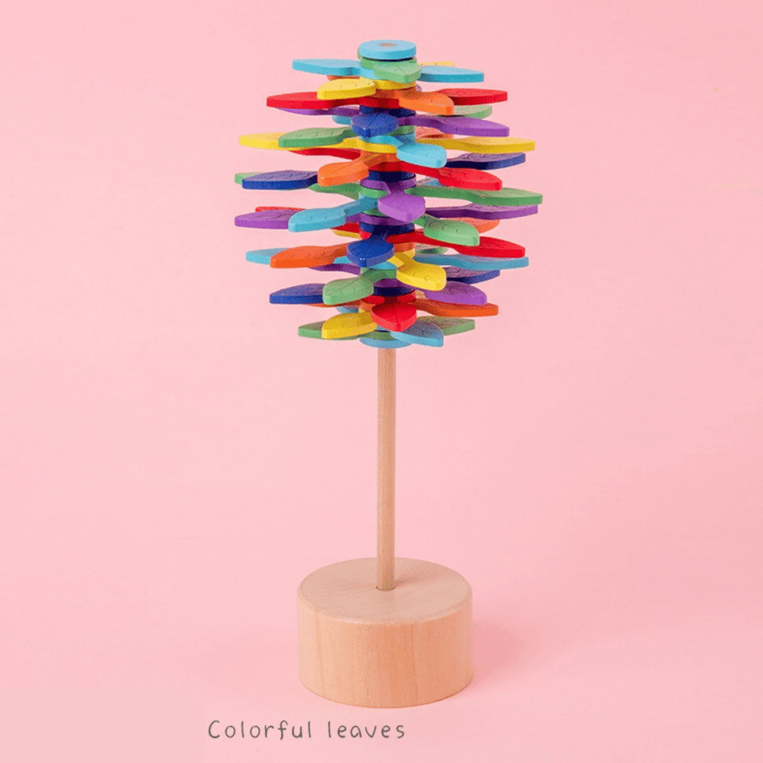 Colorful Leaves wooden rotating lollipop toy on a pink background