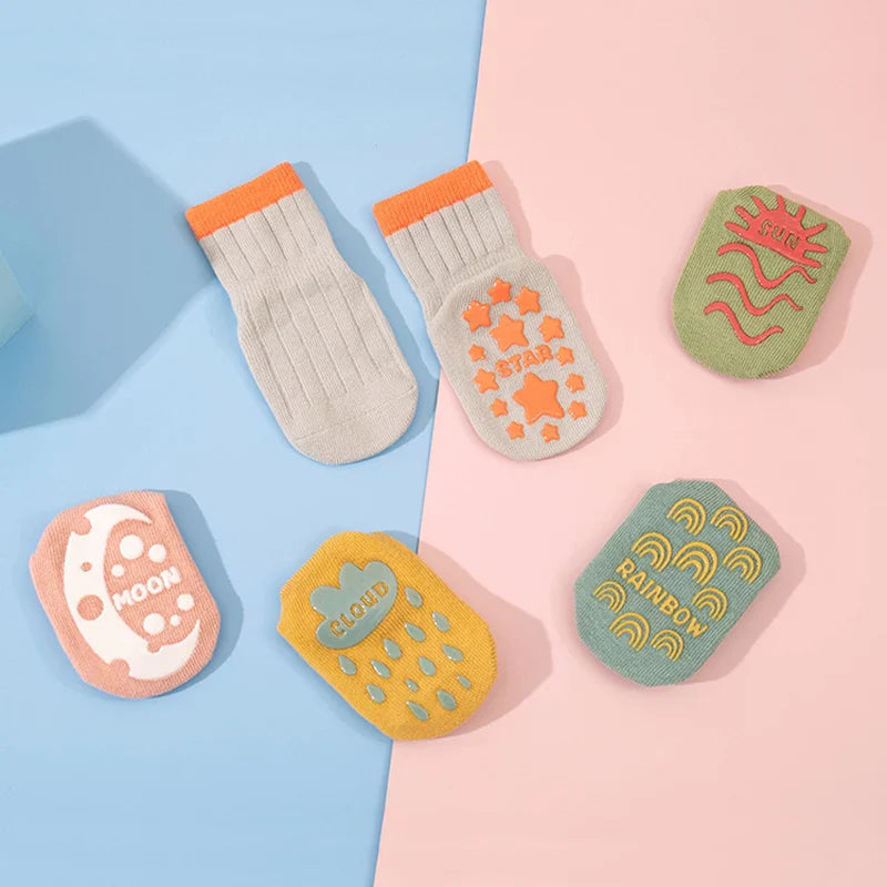 Colorful sock soles with cloud, star, rainbow, moon, and sun grip patterns