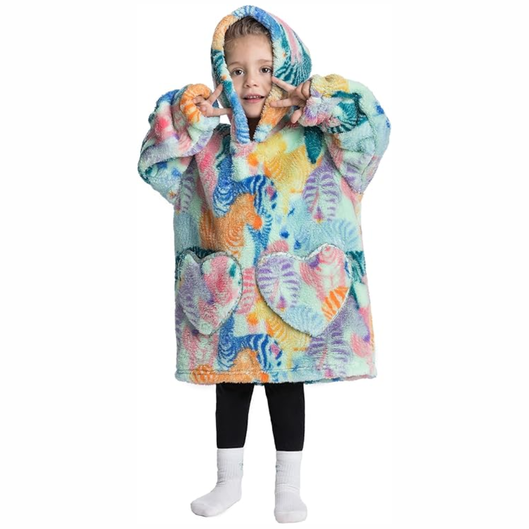 Child wearing a colorful zebra-print hooded blanket with two front pockets