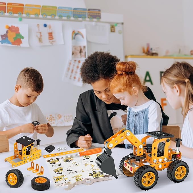Group assembling yellow metal construction vehicles with loose parts and tools on a table