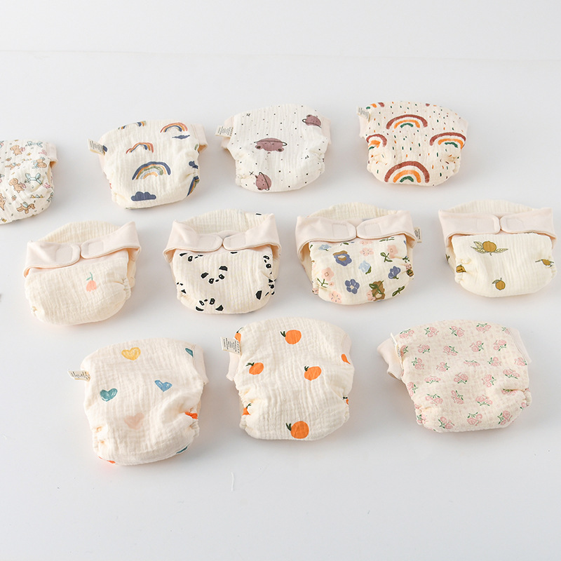 Cloth diaper print selection showing rainbow, panda, flower, orange, and heart designs
