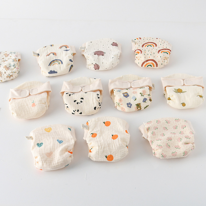 Cloth diaper print selection showing rainbow, panda, flower, orange, and heart designs