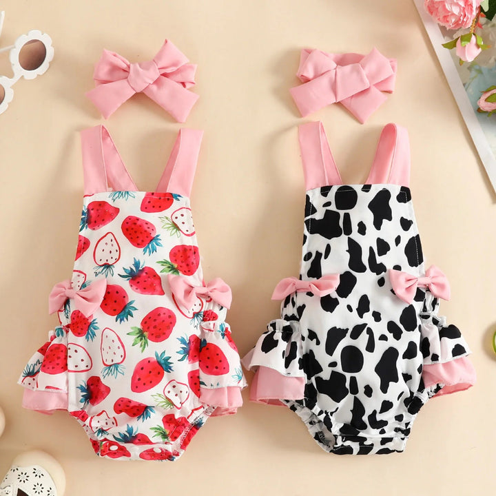 Strawberry and cow-print baby rompers with pink straps, ruffled trim and matching bow headbands