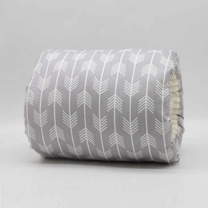 Gray nursing pillow covered in white arrow motifs.