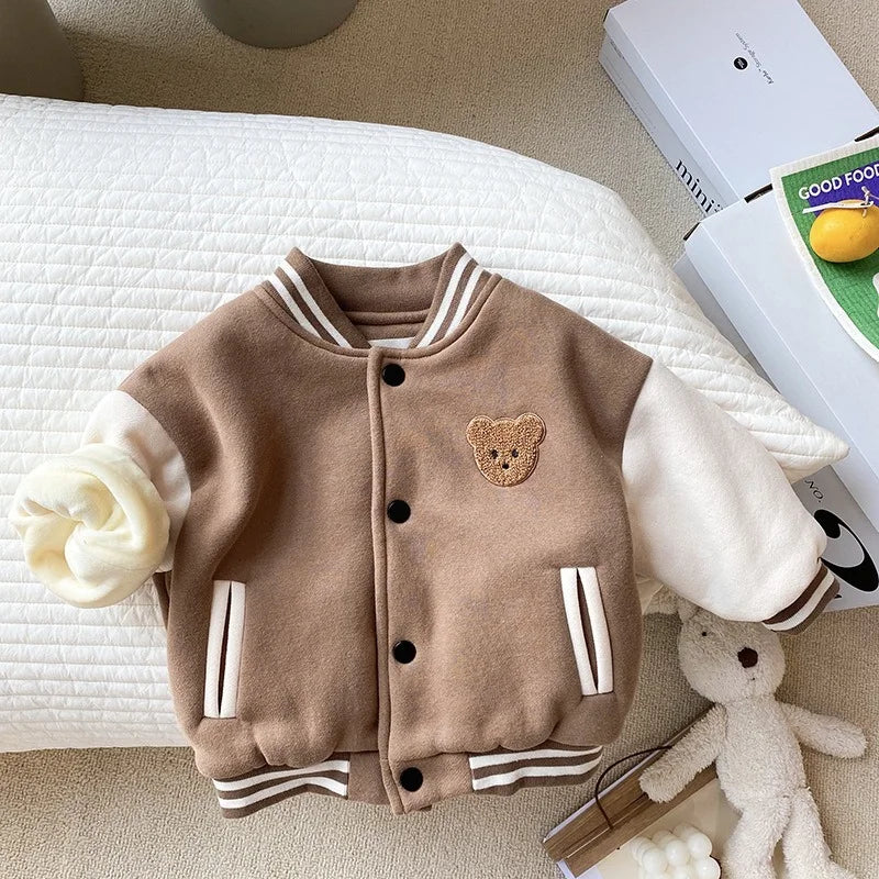 Brown fleece baseball jacket with cream sleeves, a bear patch and striped ribbed trim