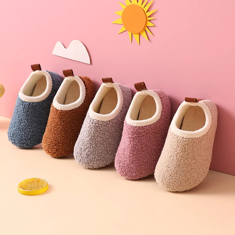 Kids' slippers in blue, brown, gray, purple, and beige with cream-colored openings and heel pull tabs