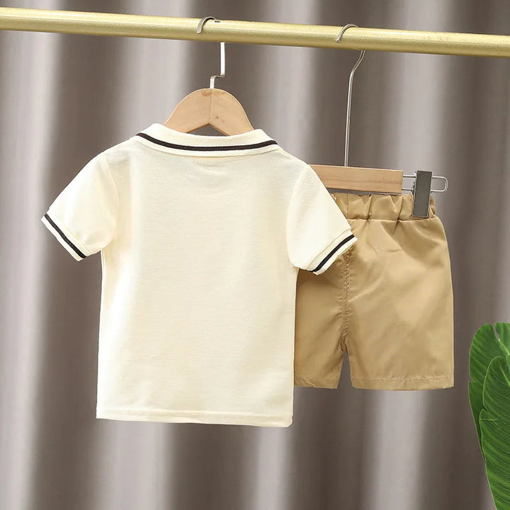 Back of the cream short-sleeve polo with beige shorts on hangers
