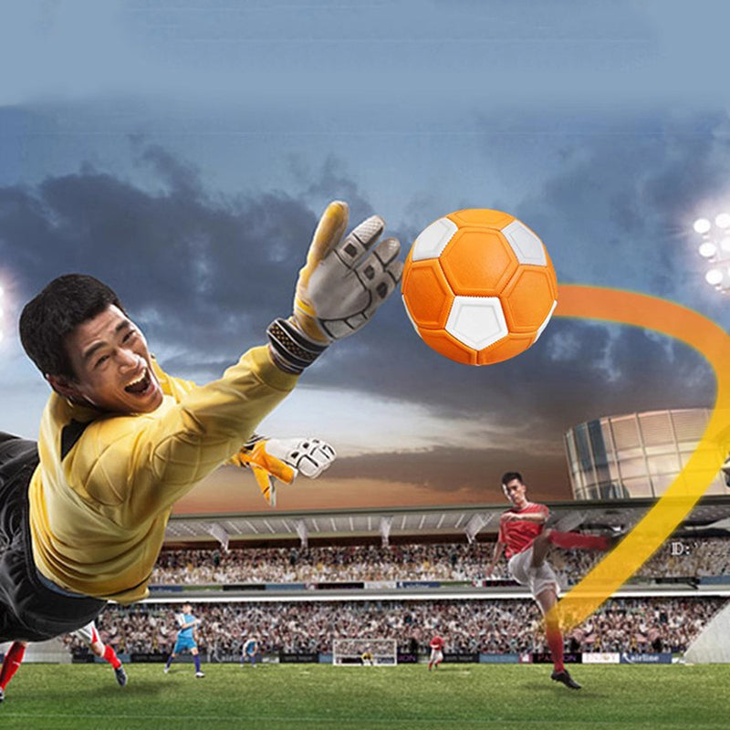 Goalkeeper reaching for an orange-and-white soccer ball with a curved trail in a stadium graphic.