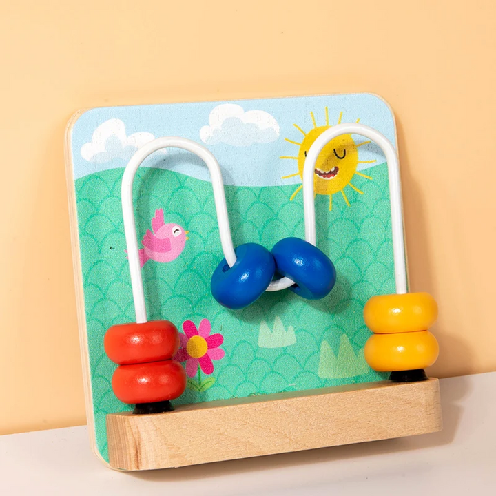 Wooden bead maze busy board with curved wire tracks and red, blue, and yellow beads.