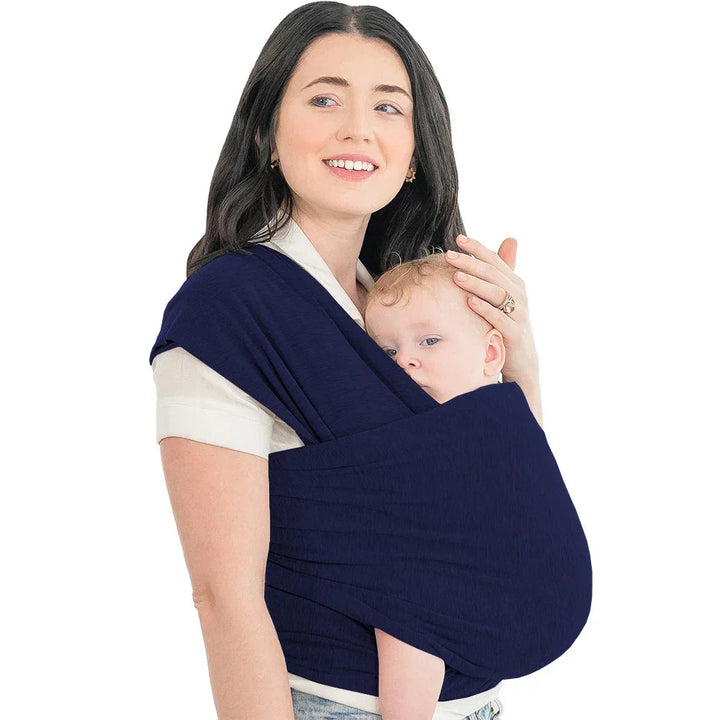 Dark blue baby wrap worn by a parent with a baby resting against her chest