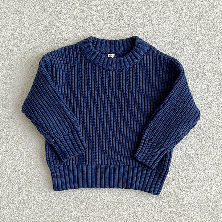 Dark blue cotton knit sweater with a round neckline, long sleeves, and ribbed cuffs and hem.