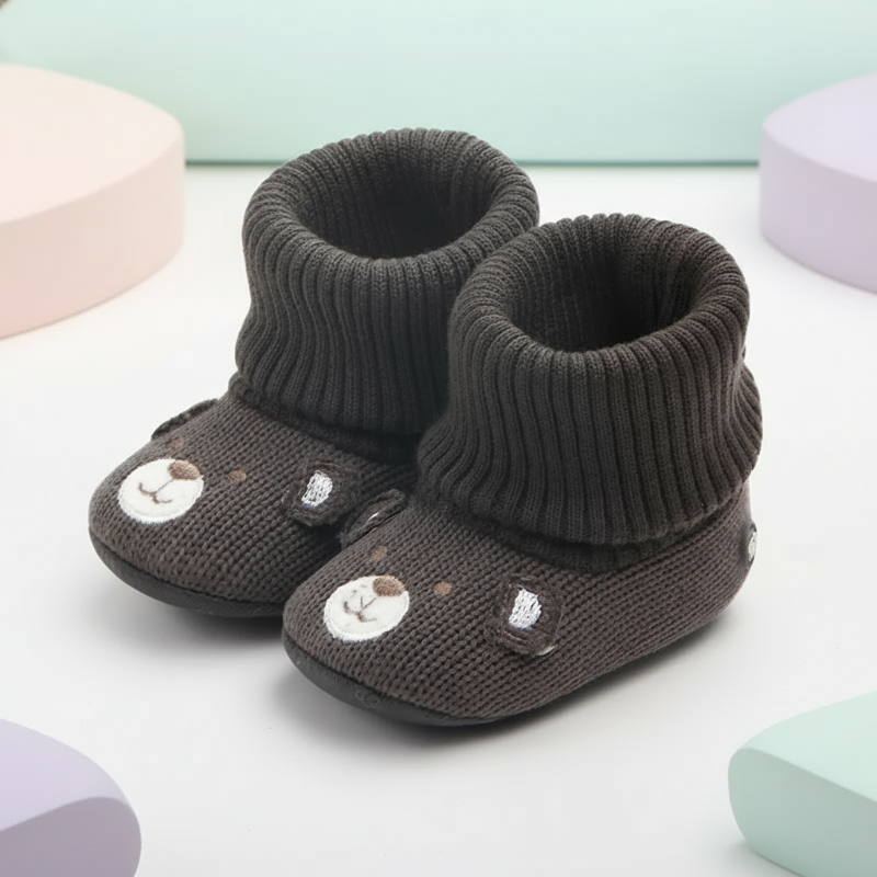 Pair of dark gray bear-face baby booties with folded ribbed cuffs.