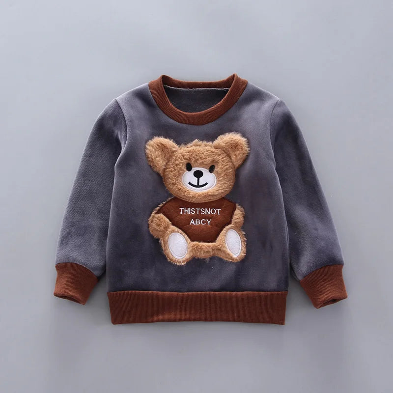 Dark gray pullover with a textured teddy-bear patch and brown collar, cuffs, and hem