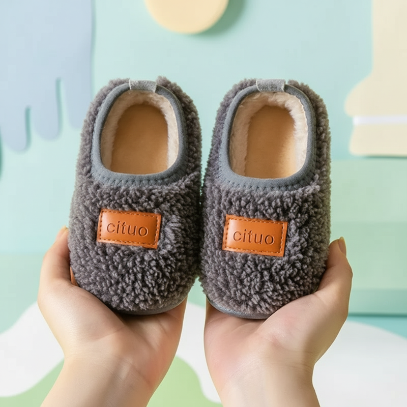 Dark gray textured winter slippers with tan patches and light gray opening trim