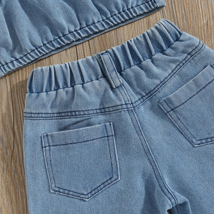 Back of the denim pants showing the gathered waistband and patch pockets