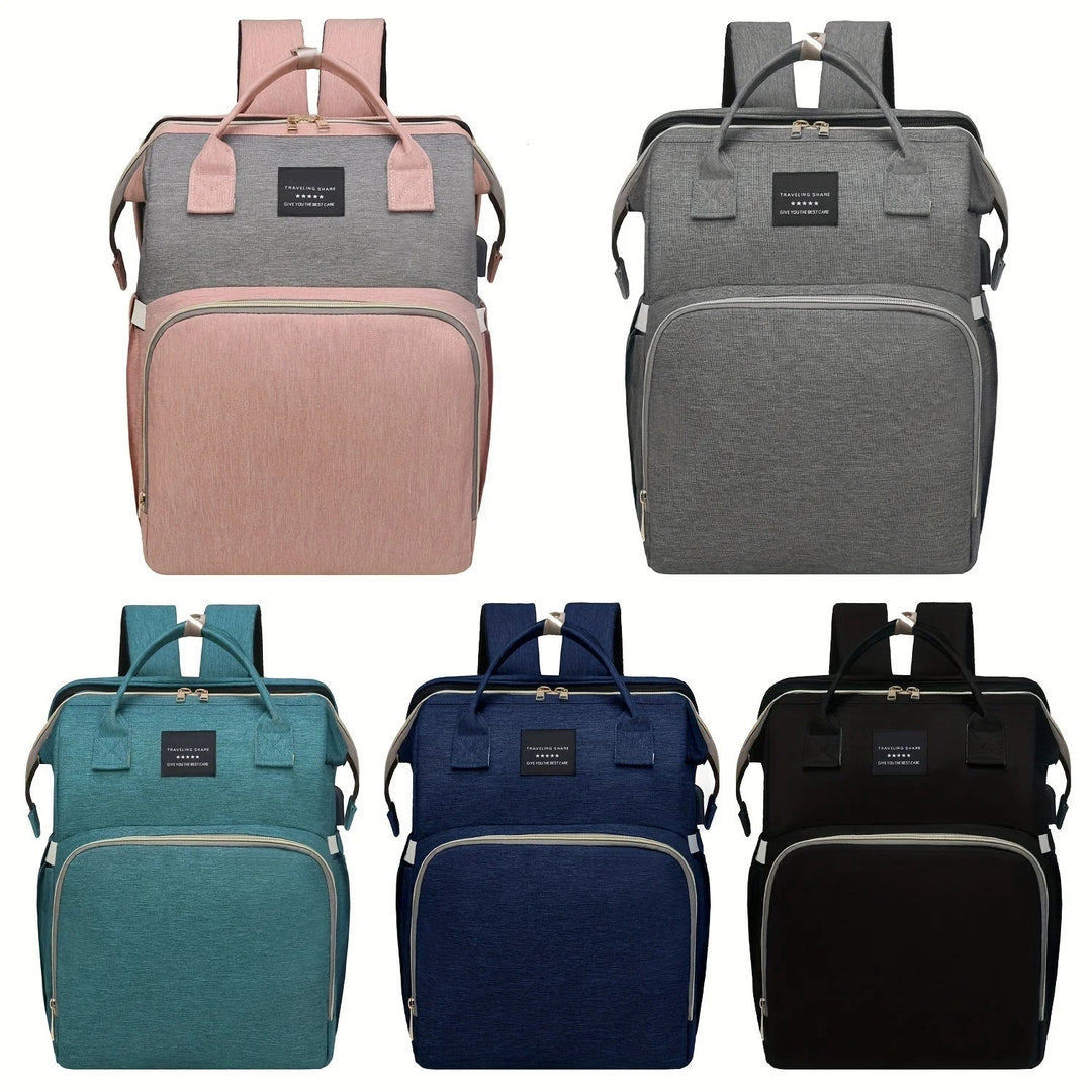 Diaper backpacks displayed in pink, gray, green, blue, and black.