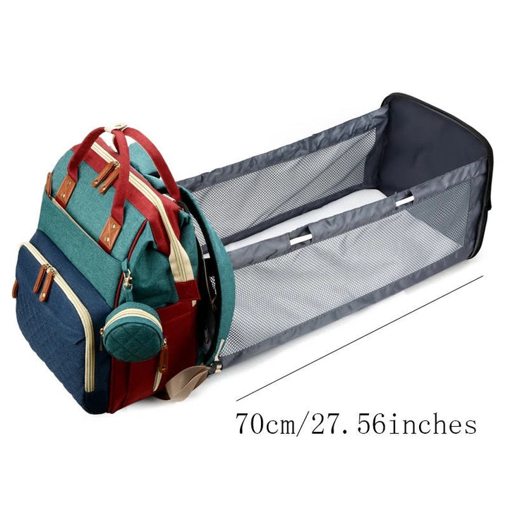 Diaper backpack unfolded into a mesh-sided baby bed with a 70 cm length label