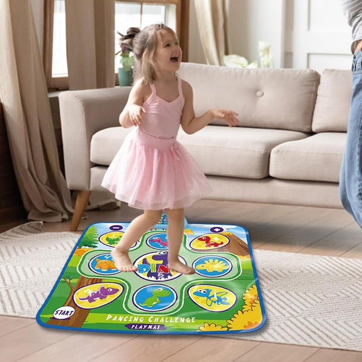 Child in a pink dress stepping on the green Dino dance mat