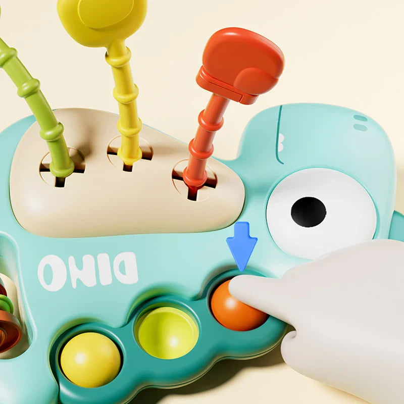 Orange pop bubble being pressed beside the dinosaur toy&