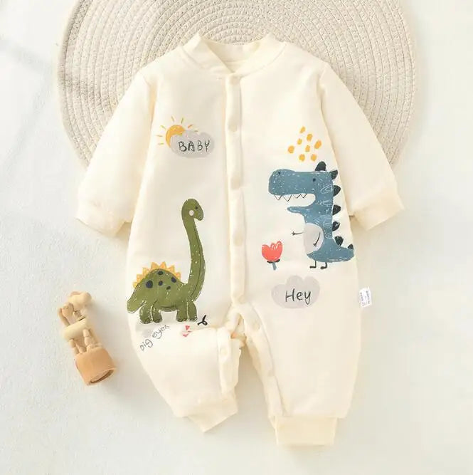 White dinosaur-print baby pajamas with long sleeves and cuffed ankles