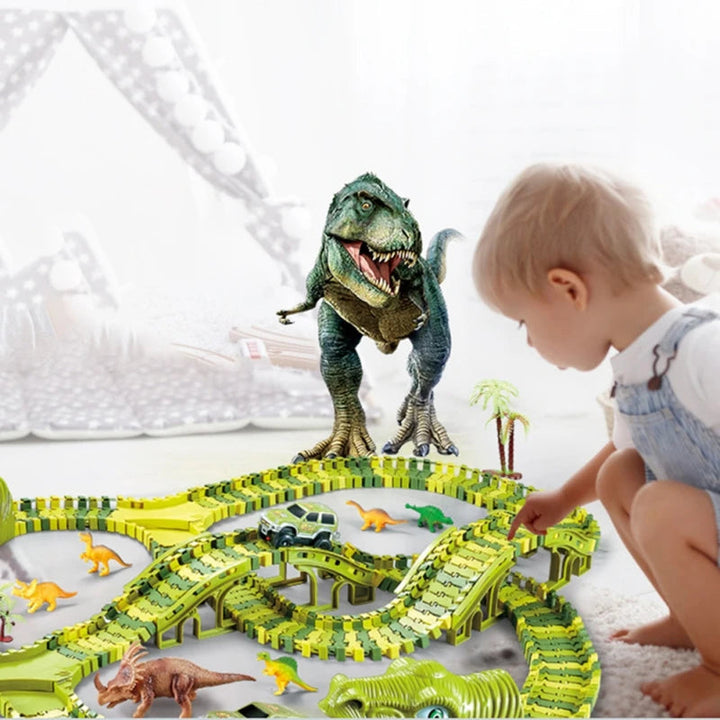 Child playing beside a green dinosaur race track with a toy car, trees, and dinosaur scenery