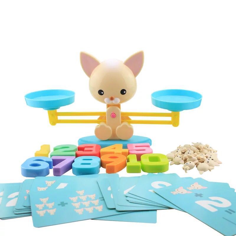 Dog counting game with numeral weights and activity cards spread in front of the scale