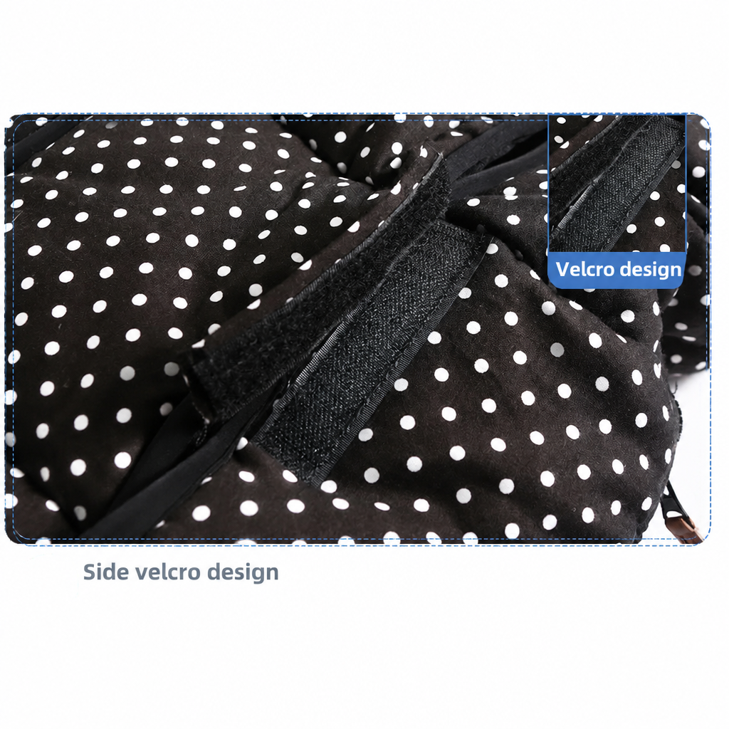 Hook-and-loop side fastening on a black stroller footmuff with white dots