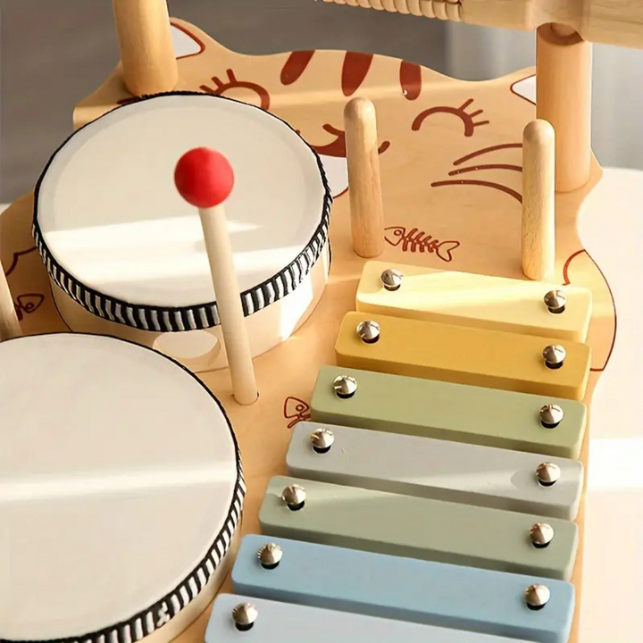 Close-up of two drumheads and pastel xylophone bars on the cat-shaped wooden base