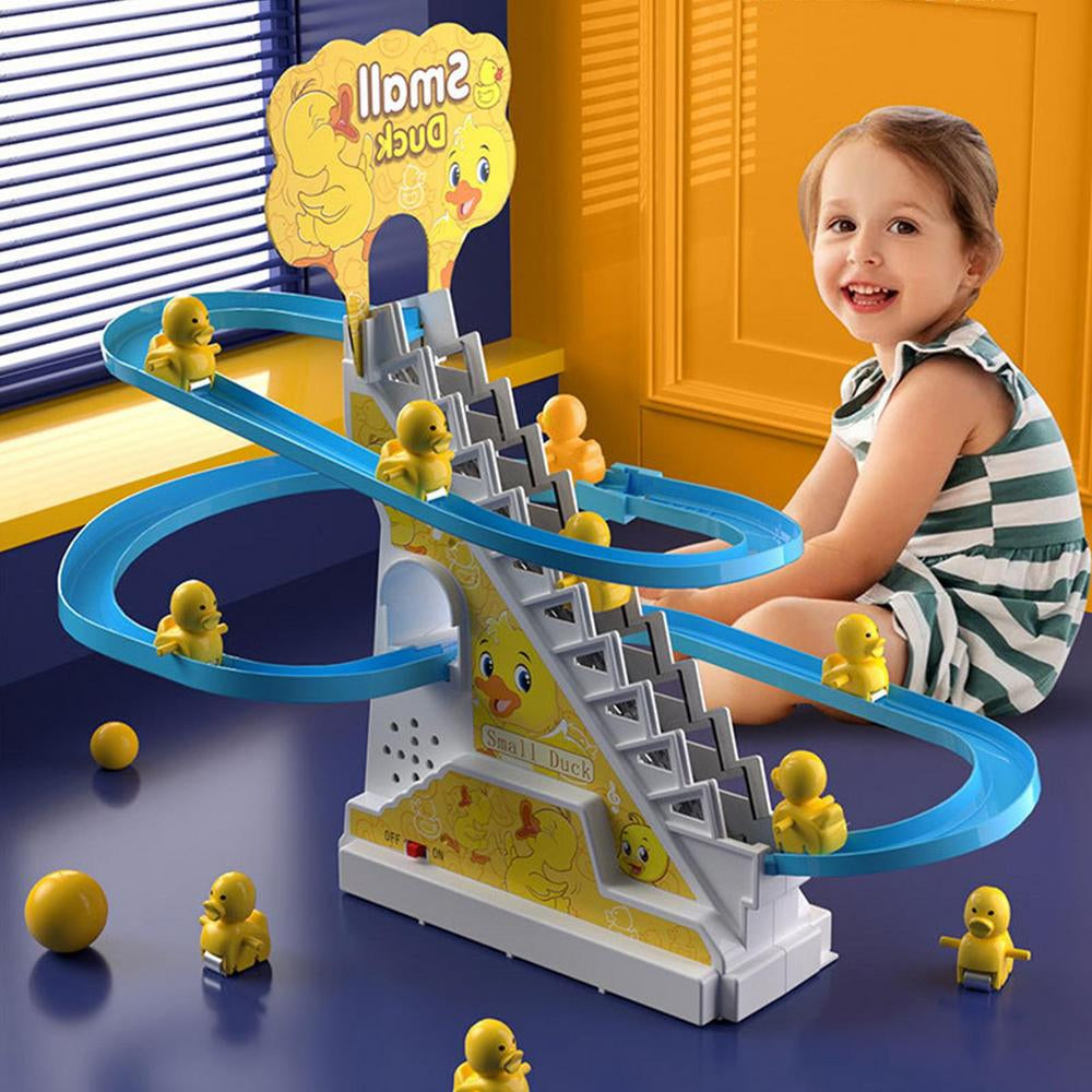 Child beside a duck slide toy with yellow ducklings, a blue track, and a central stairway.