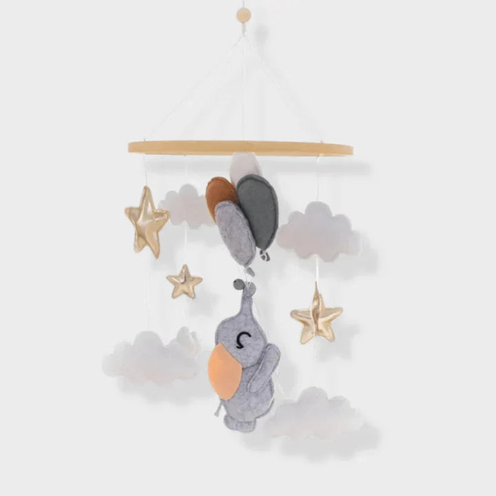 Elephant baby mobile with gray clouds, stars, and a cluster of balloon shapes