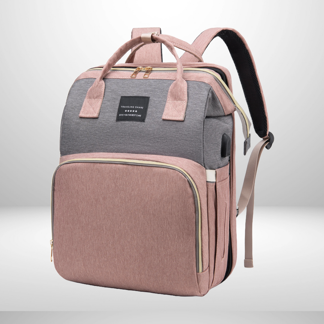 Pink and gray diaper backpack with top handles and a zippered front pocket.