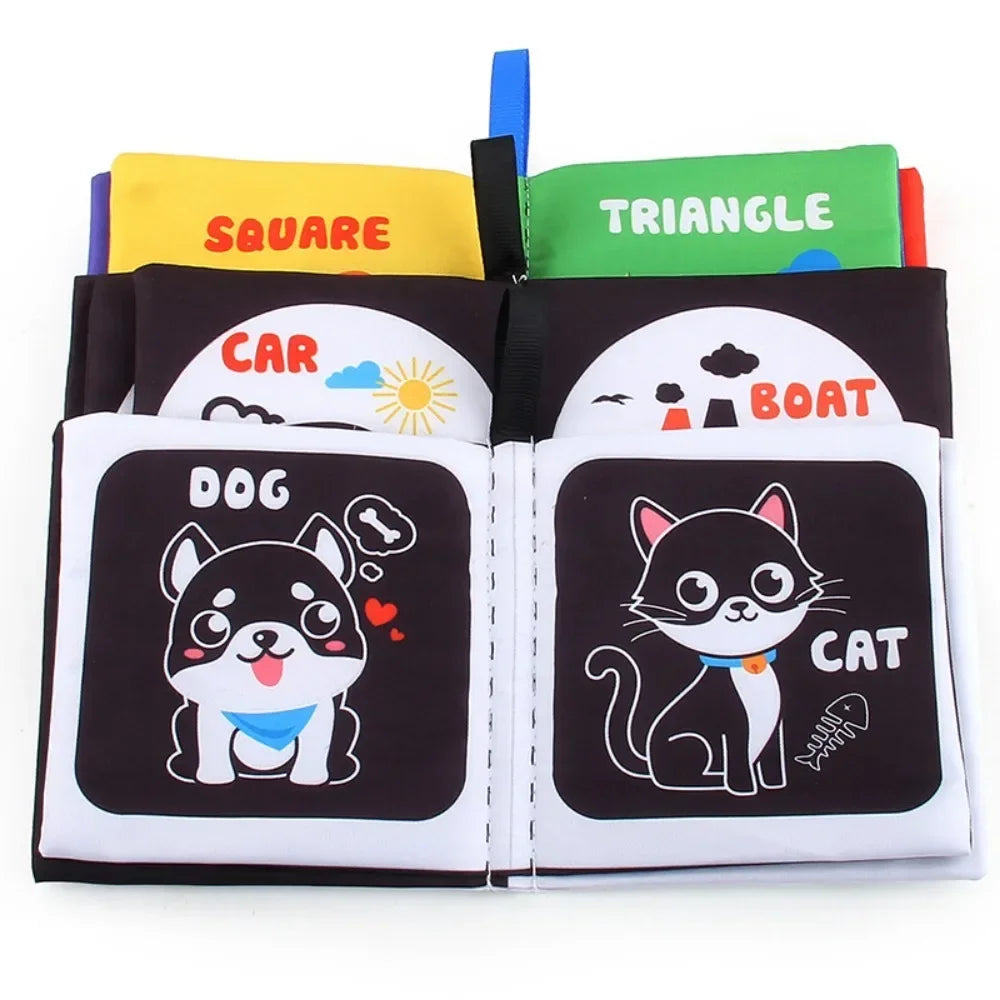 Open fabric books with dog and cat illustrations in front of vehicle and shape pages
